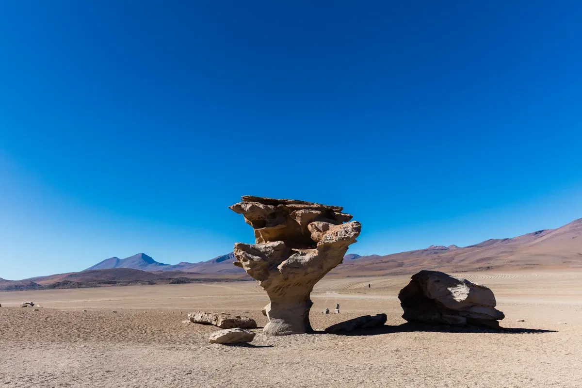 The wind-carved Árbol de Piedra rock in the Siloli desert on an Uyuni salt flats tour